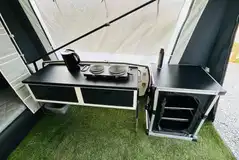 Isabella ready tent camp kitchen with a stove, kettle and storage