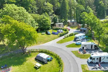 Aerial of the grass/hardstanding pitches and shepherd's huts