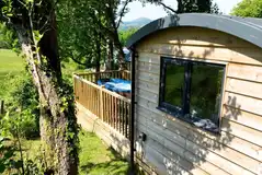 Ensuite shepherd's huts with wooden decks and electric hot tubs