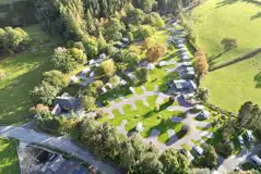 Aerial of Pen y Bont Touring Park surrounded by woodland and countryside