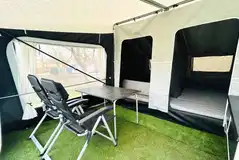 Isabella ready tent with camp chairs, a table, camp kitchen and mattresses