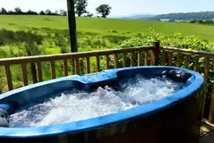 Ensuite shepherd's huts with wooden decks and electric hot tubs