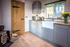 Shepherd's hut kitchen with a sink, fridge, microwave, toaster and kettle