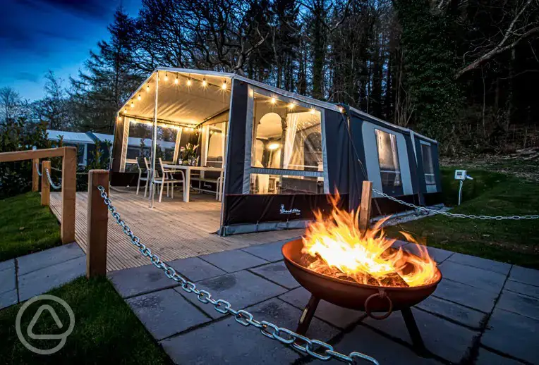 Isabella glamping safari tent with a fire pit at night