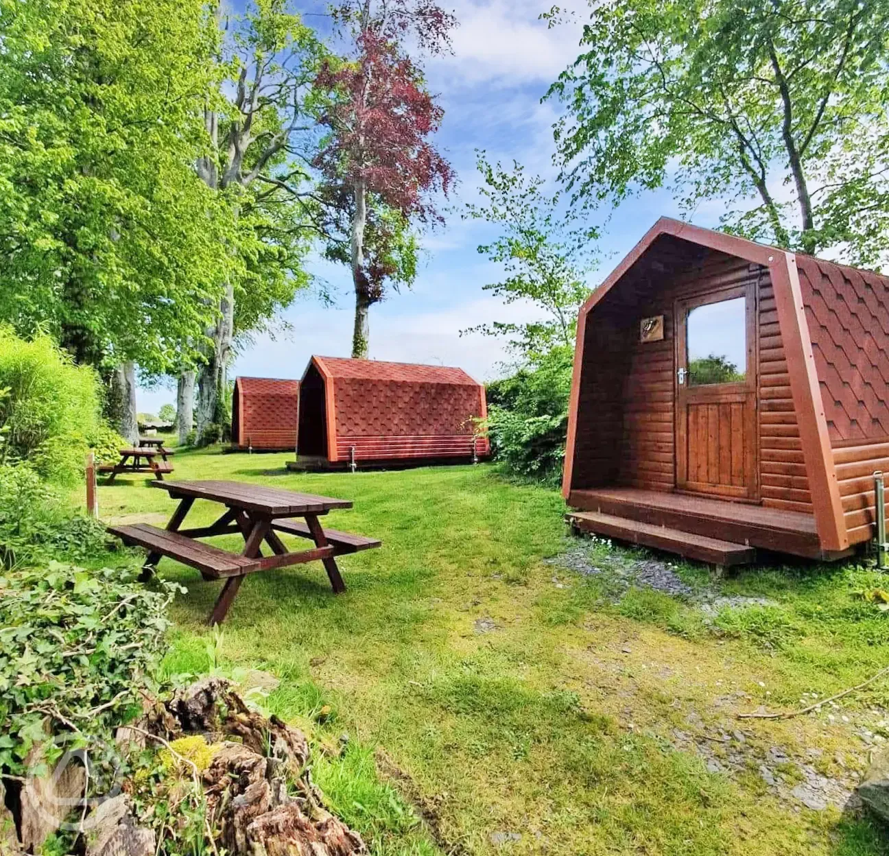 Camping pods located in a private part of the site with picnic benches