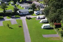 Aerial of the hardstanding pitches, backed by the camping pods