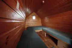 Camping pod interior with bench-style mattresses