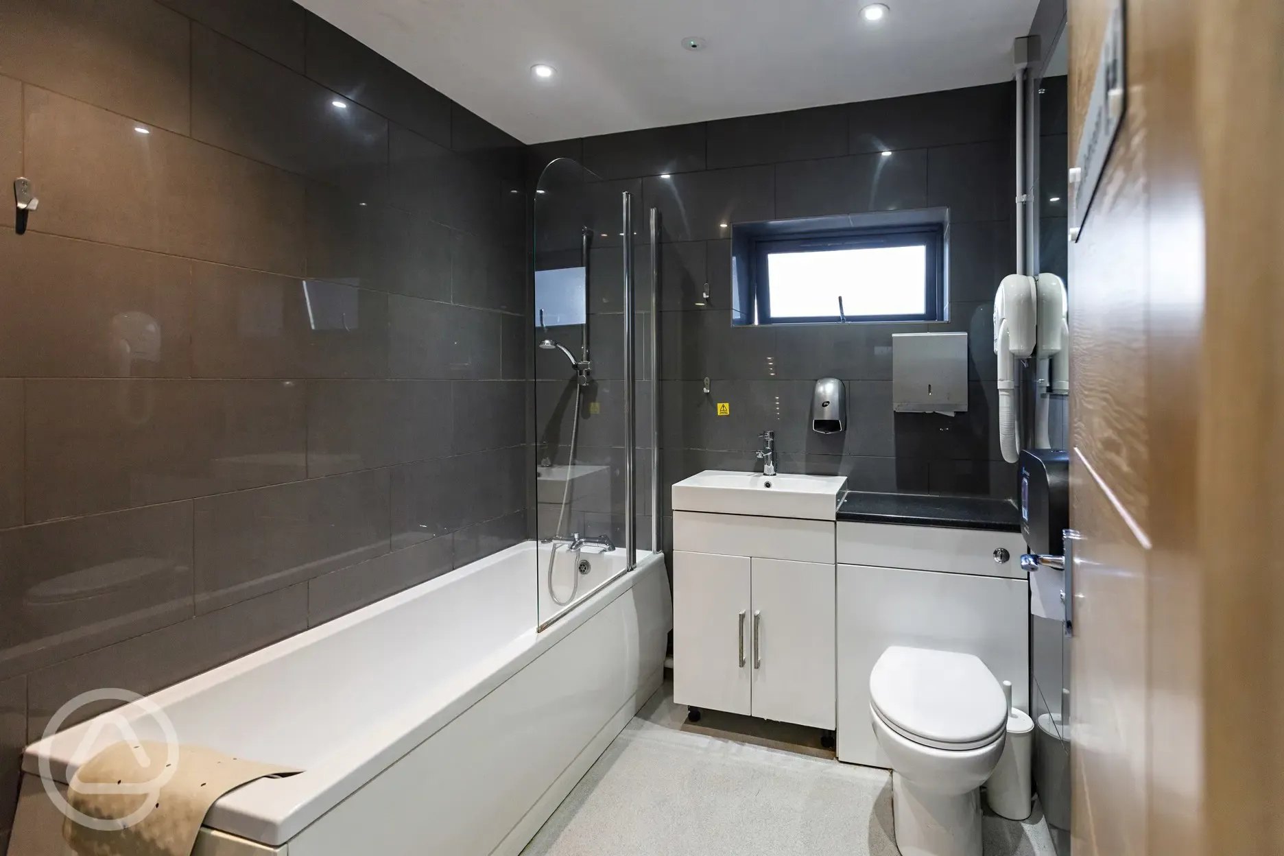Family bathroom with bath, shower, and hair dryer