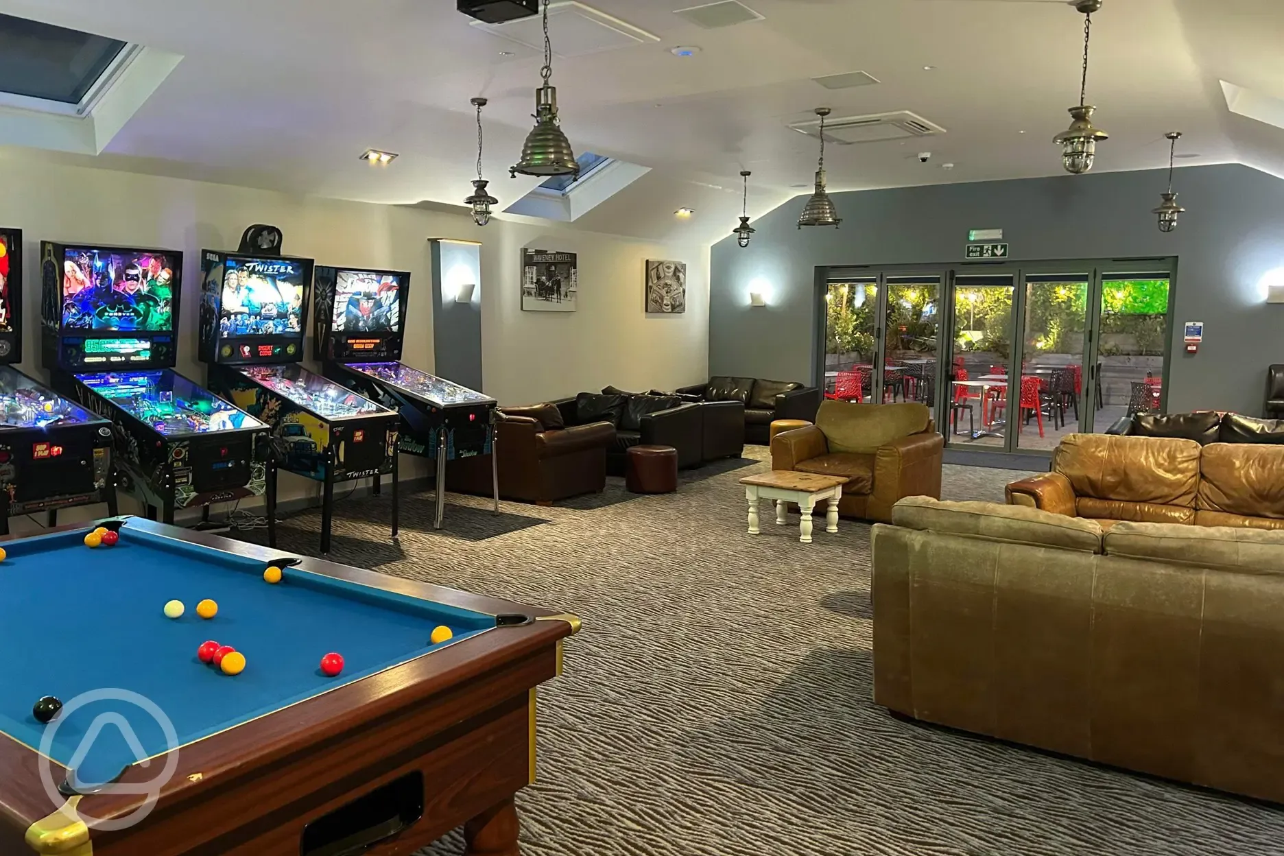 Games room with arcade games and pool