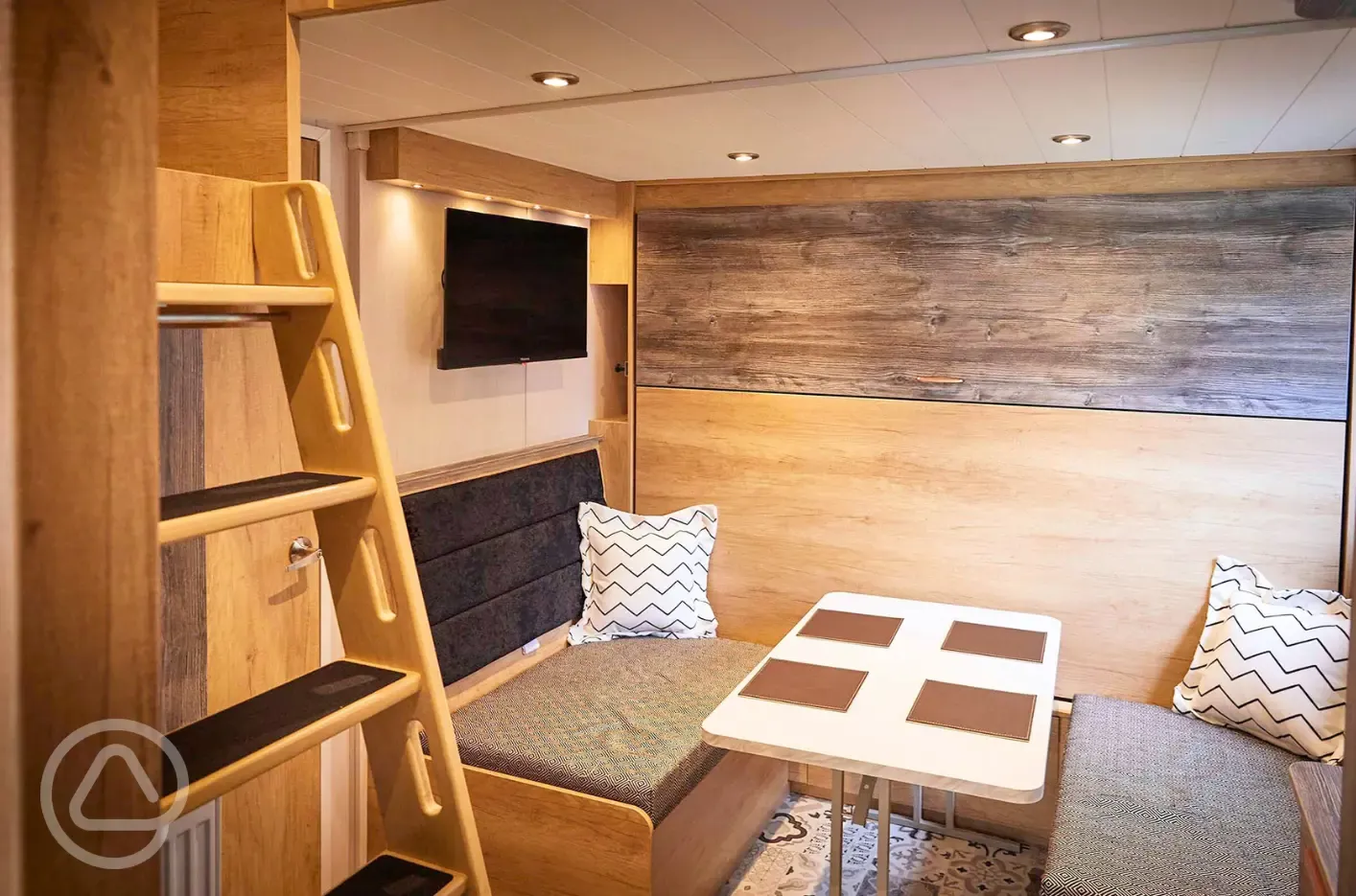 Forest glamping pod dining area with pull down double bed