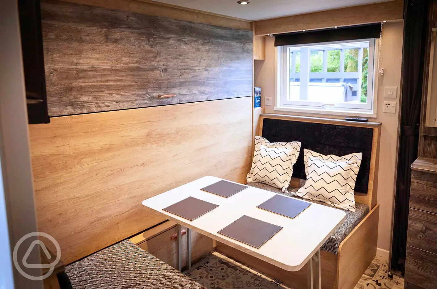 Forest glamping pod dining area with pull down double bed