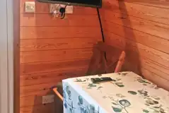 Glamping pod TV and dining area