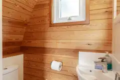 Glamping pods ensuite toilet with a sink and mirror Glamping pods ensuite toilet with a sink and mirror