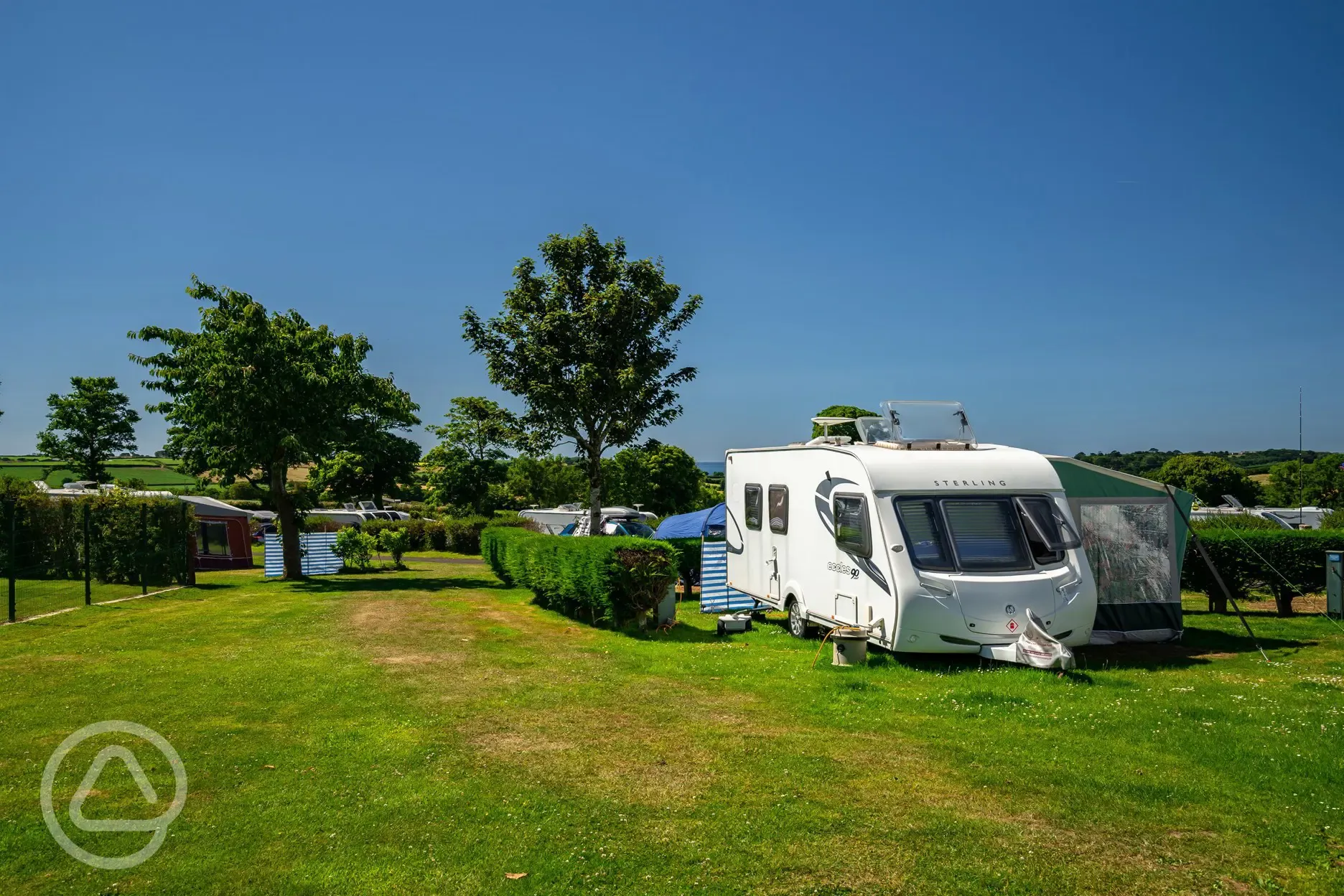 Caravan and awning on grass pitches at Tregarton Park