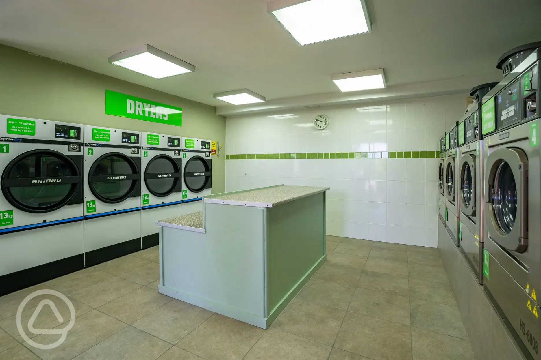 24 hour laundry room with coin-operated washing machines and dryers
