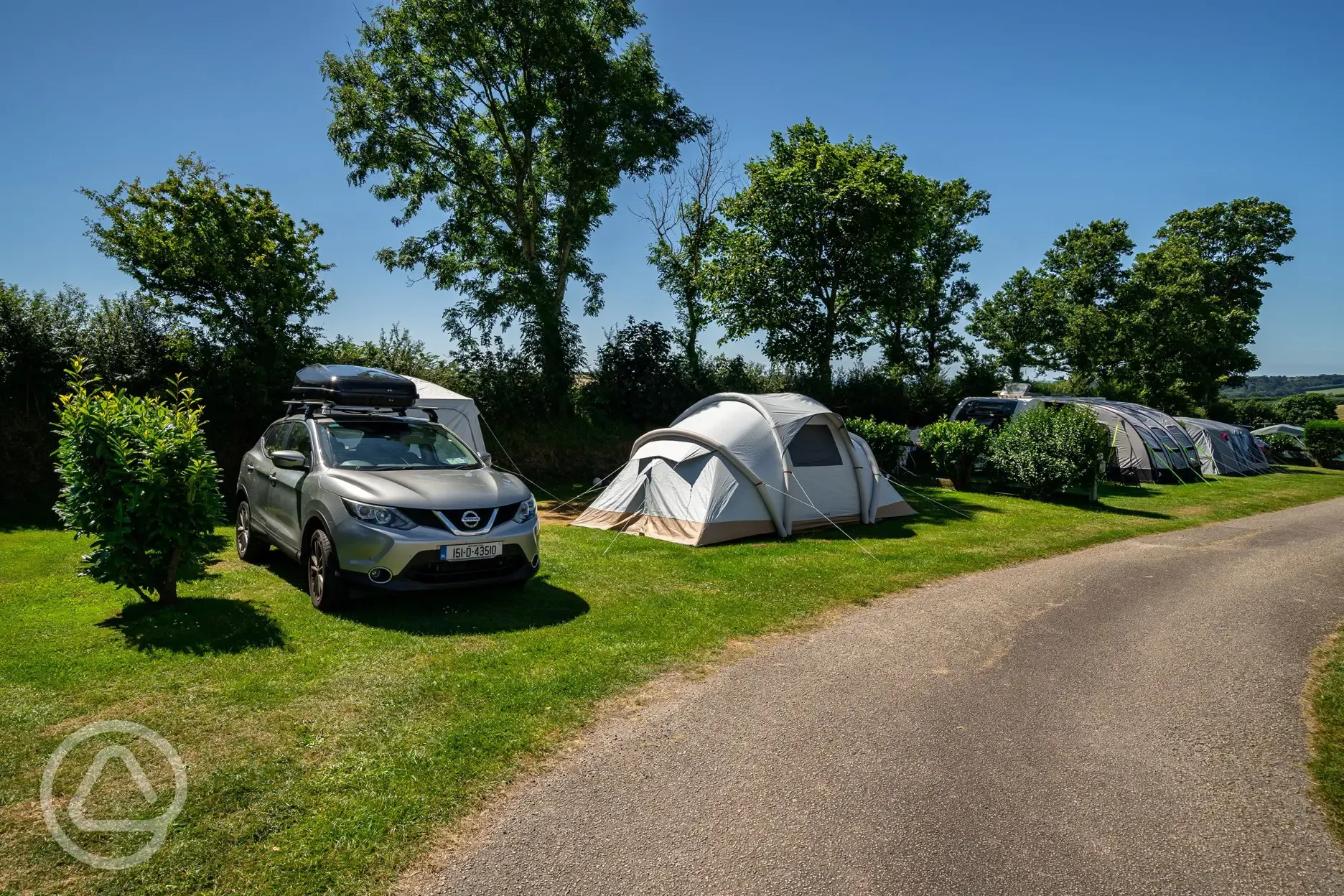 Tent on grass pitches at Tregarton Park with car parking space