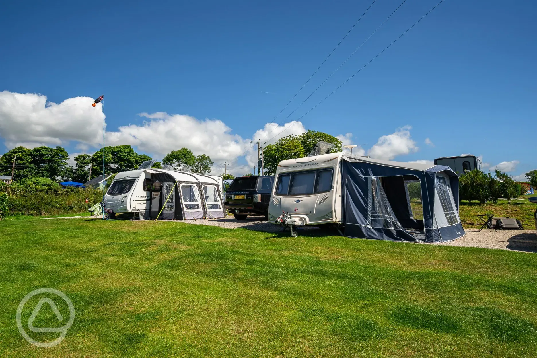 Caravan and awning on electric hardstanding pitches at Tregarton Park