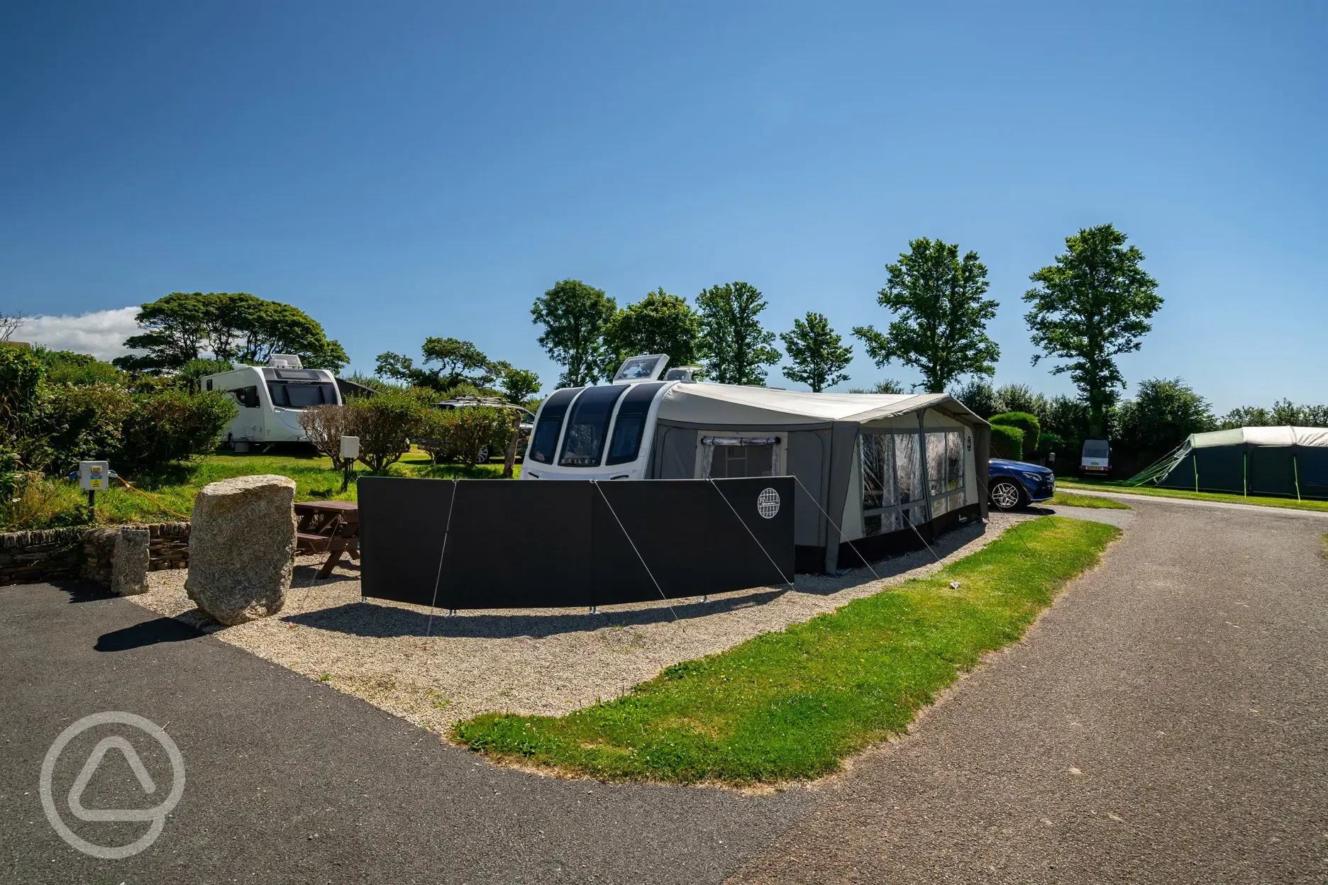 Caravan and awning on electric hardstanding pitches at Tregarton Park