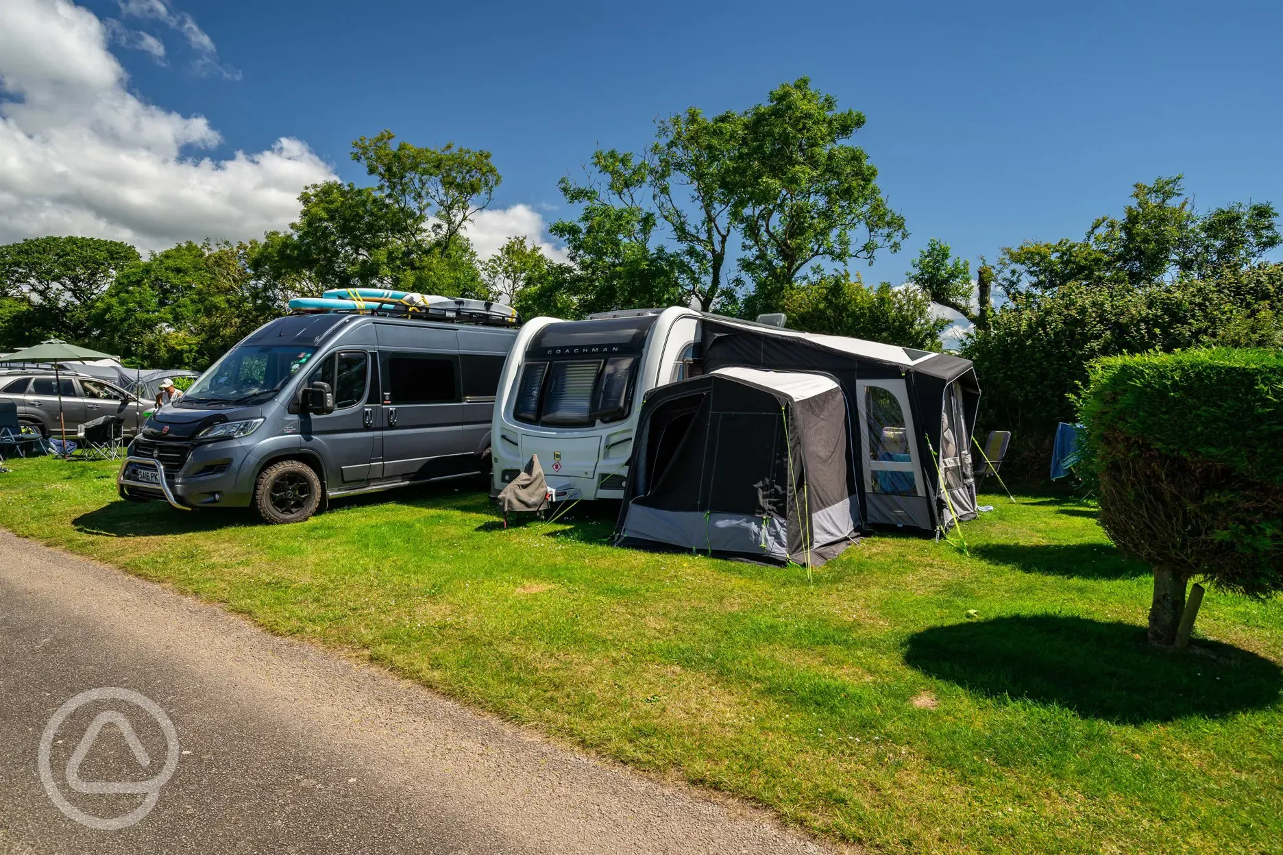 Grass pitches at Tregarton Park with awning space