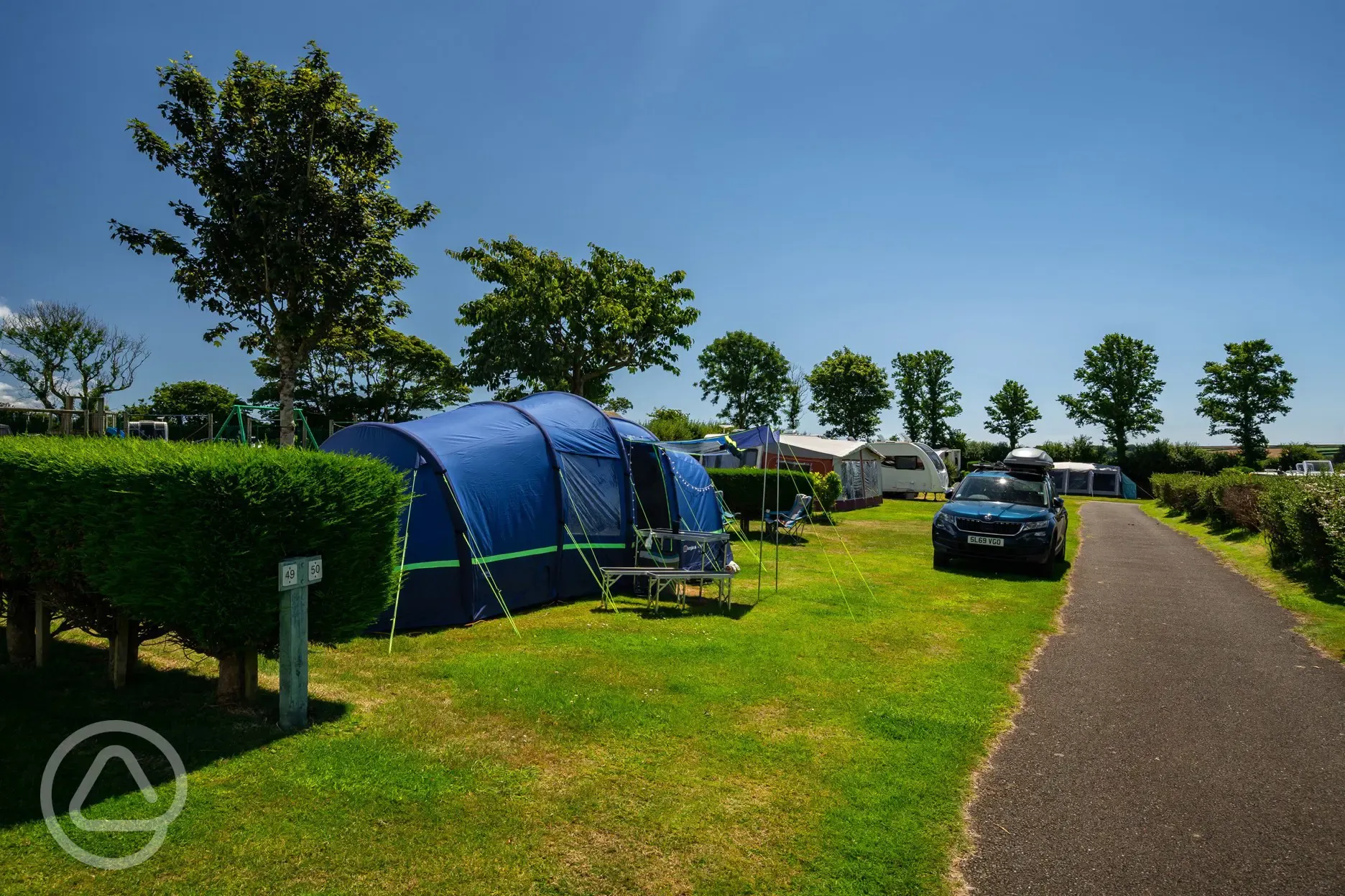 Tent on grass pitches at Tregarton Park with car parking space
