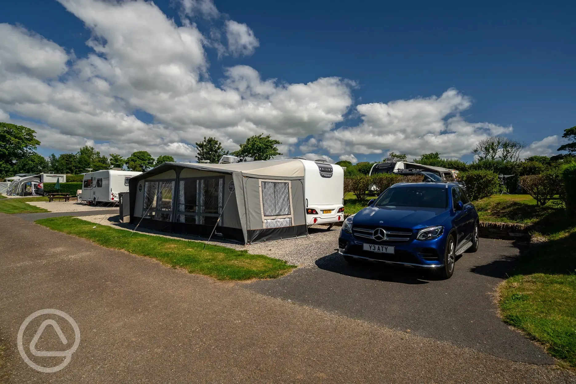 Caravan and awning on electric hardstanding pitches at Tregarton Park 