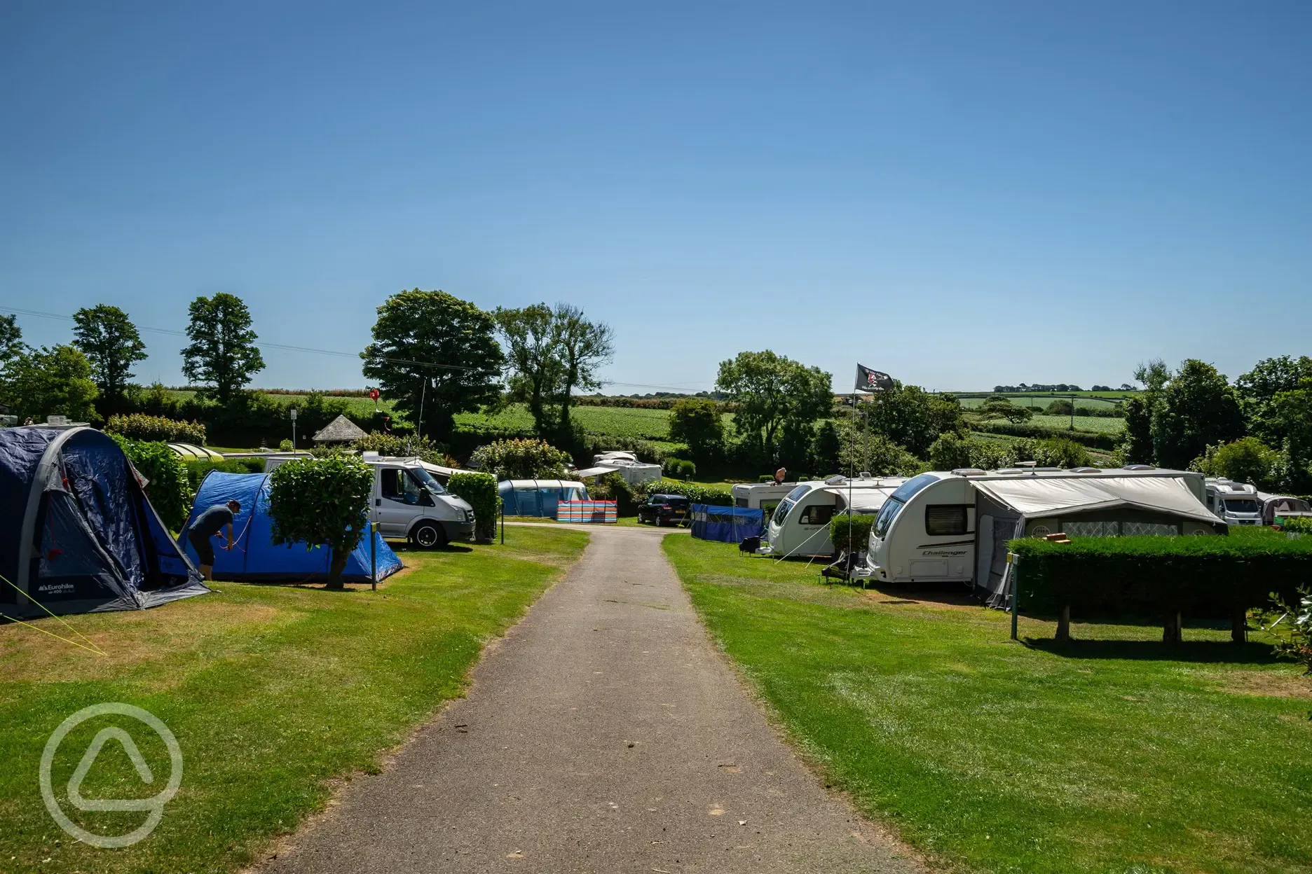 Caravans and tents on grass pitches at Tregarton Park