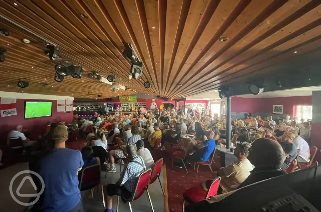 Campers watching a football game in the bar