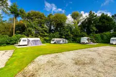 Electric grass and gravel pitches with space for an awning