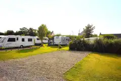 Fully serviced hardstanding touring pitches with electric, water, and grey waste