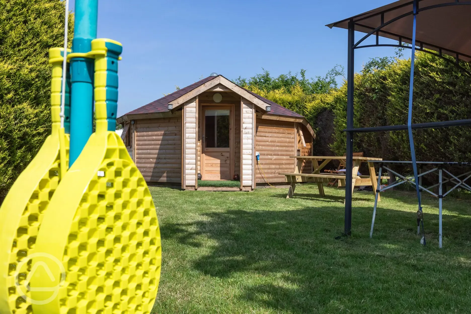 Glamping cabin with swing ball and outdoor covered area