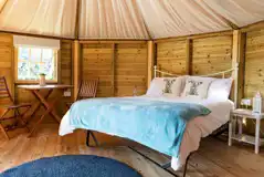 Glamping cabin interior with a double bed (bedding can be hired)