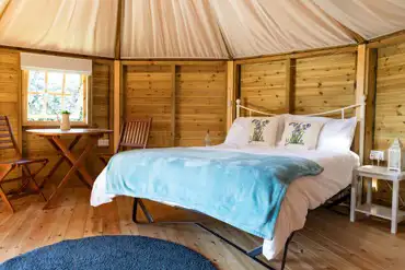 Glamping cabin interior with a double bed (bedding can be hired)