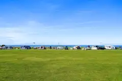 Grass pitches with sea views at Trevalgan Touring Park