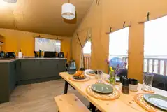 Safari tent open-plan living and kitchen area Safari tent open-plan living and kitchen area
