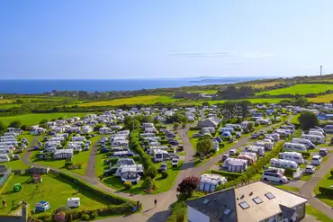 Aerial of Polmanter Touring Park with a tennis court and sea views
