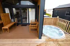 Designer studio suite with a deck, hot tub and sheltered seating area Designer studio suite with a deck, hot tub and sheltered seating area