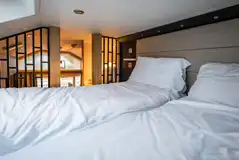 Designer studio suite mezzanine level with twin beds Designer studio suite mezzanine level with twin beds