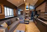 S-pod with a sofa, mezzanine level, kitchen and bedroom to the rear