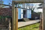 Shepherd's hut set within a gated garden area