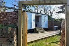 Shepherd's hut set within a gated garden area