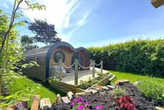 Glamping pod lodge with a large wrap-around deck with a hot tub Glamping pod lodge with a large wrap-around deck with a hot tub
