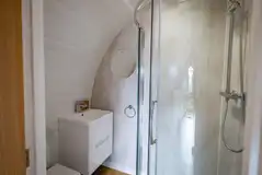 Luxury glamping pod ensuite with a toilet, hand basin and shower Luxury glamping pod ensuite with a toilet, hand basin and shower