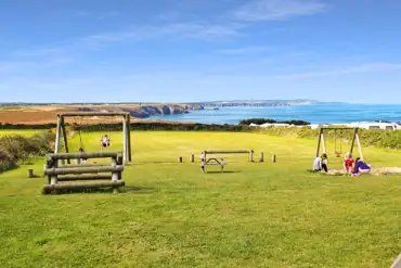 Grass pitches and play park in The Meadow