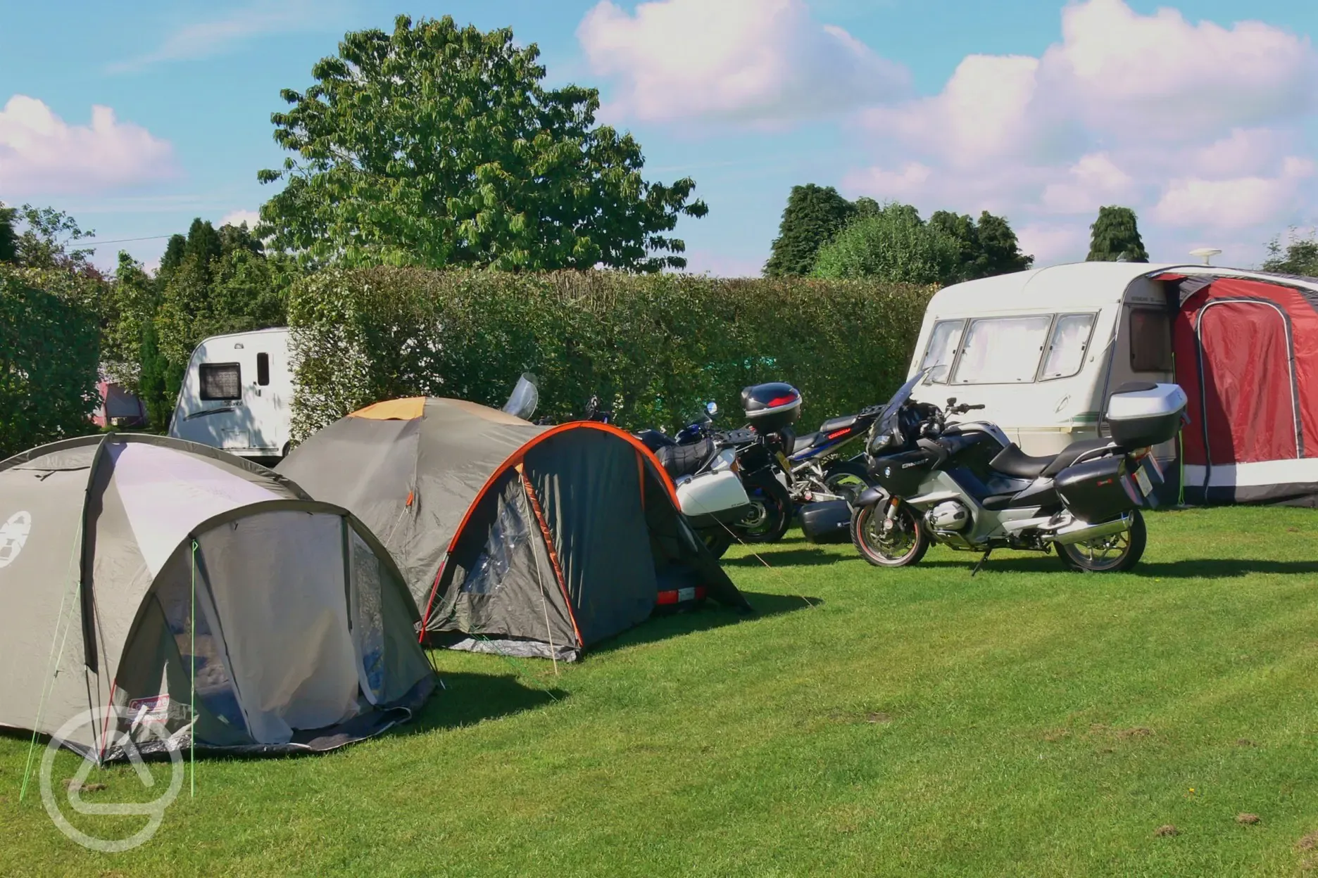 Motorbikes and tents at Arosa Park campsite