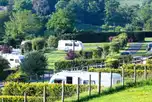 Fully serviced hardstanding super pitches with hedging between