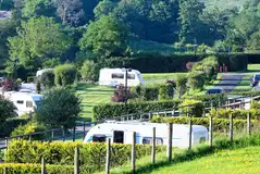 Fully serviced hardstanding super pitches with hedging between