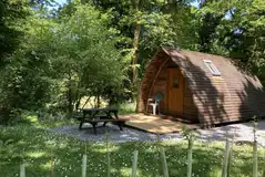 Wooden camping pod with a picnic bench