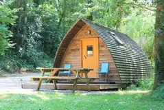 Wooden camping pod with a picnic bench
