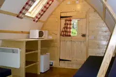Wooden camping pod with a fridge, kettle and microwave