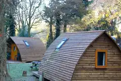 Wooden camping pod with a picnic bench